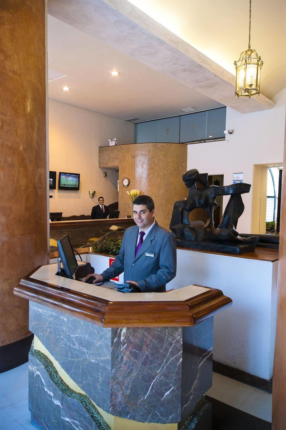 J&A Classic Hotel Lima Bagian luar foto A hotel receptionist at the check-in counter